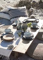 Low table and cushions on beach  