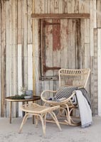 Furniture outside rustic wooden house 