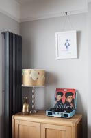 Portable record player on sideboard in retro style living room 