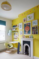 Childrens room with bright yellow feature wall 