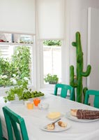 Toy cactus next to green and white dining table 