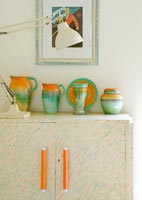 Colourful pottery on vintage cabinet 