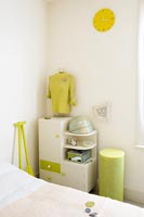 Retro bedside table in lime green and white bedroom 
