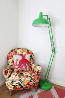 Floral armchair and large green floor lamp 
