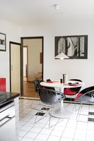 Black, white and red dining area in modern kitchen-diner 