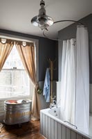 Vintage bathroom with circular shower curtain rail over bath