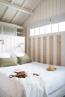 Country bedroom with wooden feature wall 