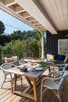 Outdoor living and dining area on decked terrace, summer 
