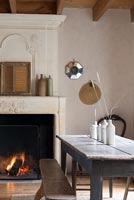 Country dining room with lit fire