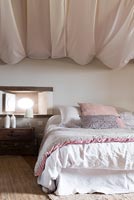 Billowing fabric covered ceiling in country bedroom 