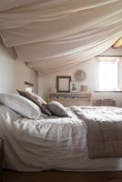 Billowing fabric covered ceiling in country bedroom 