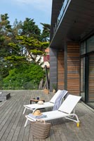 Modern terrace with sun loungers 