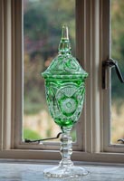 Ornate green vase on windowsill 