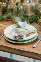 Decorative dove Christmas decoration on dining table setting 