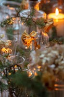 Dried flowers in vases and candles on Christmas dining table 