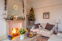 Lit fire in country living room at Christmas 