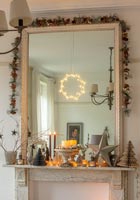Large mirror over fireplace decorated for Christmas 
