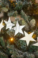 Musical score paper stars on Christmas tree 