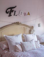 Girls name in lettering over bed 