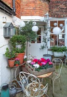 Small courtyard patio with cafe table and plants 