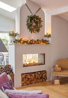Modern fireplace with wreath and Christmas decorations 