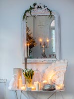 Vintage table and mirror with candles and decorative plaster at Christmas 