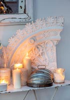 Vintage plaster artifact with candles on metal table 