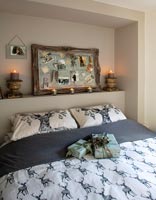 Grey and white modern bedroom with gifts and candles 