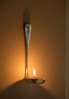Vintage silver spoon fashioned into a wall mounted candle holder. 