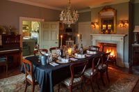 Classic dining room with lit fire at Christmas 