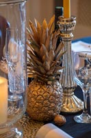 Gold painted pineapple as dining table decoration 