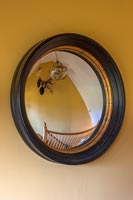 Black and gold rimmed convex mirror 