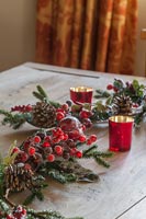 Christmas decorations on wooden table with candles 
