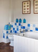 Patchwork style blue and white tiling in classic bathroom 