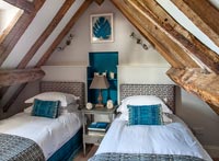 Vaulted ceiling in country bedroom with twin beds 