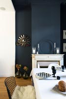 Dark blue painted walls in dining room 