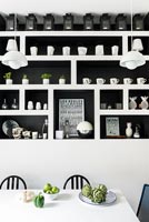 Black and white built-in shelving unit in modern kitchen diner 
