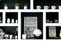 Black and white shelf unit with monochrome pictures and ceramics 