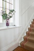 Brown sisal carpet on classic staircase 