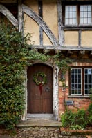 Christmas wreath on exterior of front door -  old country house 