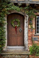 Christmas wreath on exterior of front door -  old country house 