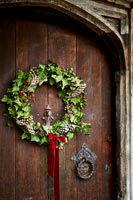 Close up of Christmas wreath on wooden front door 