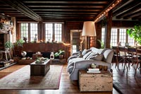 Fairy lights around wooden beams of country living room at Christmas 