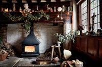Large fireplace with wood burning stove and Christmas decorations 