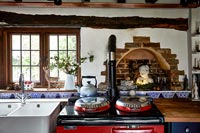 Country kitchen with red Aga stove with Christmas decorations 