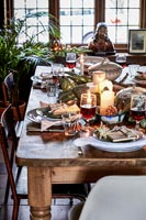 Country dining table laid for Christmas dinner 
