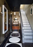 Silver staircase in monochrome modern hallway 