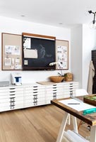 Large black and white drawers and blackboard in modern study 