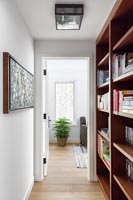 Wooden bookcase in corridor 
