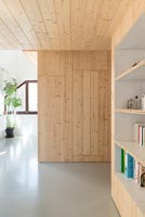 Wooden feature wall with concealed door and built-in bookcase